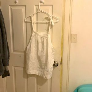 White dressy tank top with one strap tied around shoulder